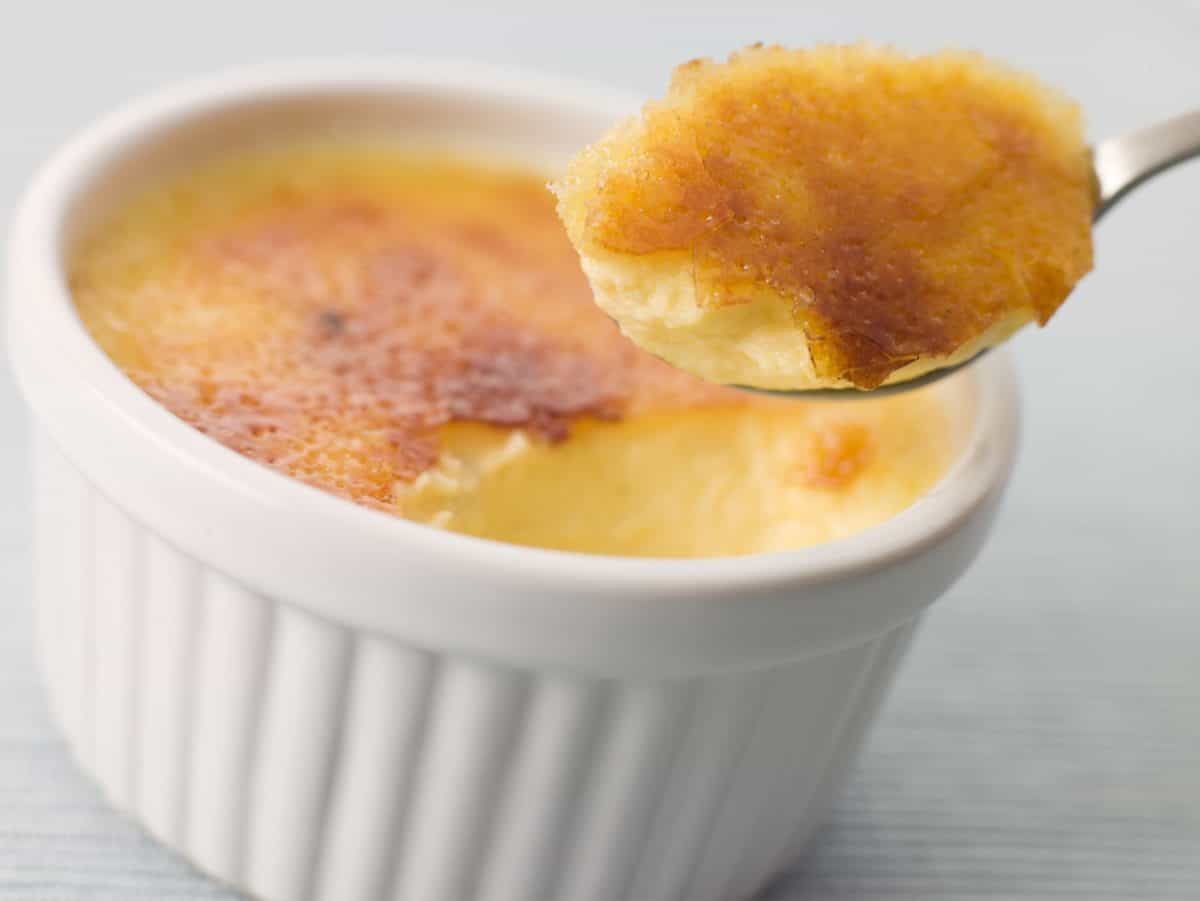 A closeup of a spoonful of Crème Brulee.