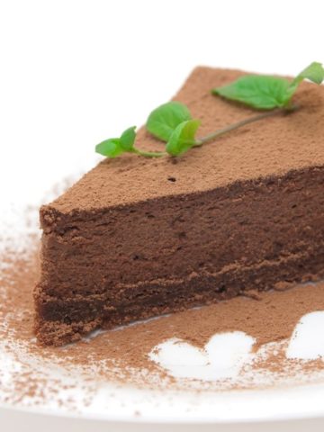 A slice of no-bake chocolate cheesecake on a white plate.