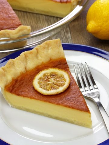 A slice of southern buttermilk pie on a plate with a fork.