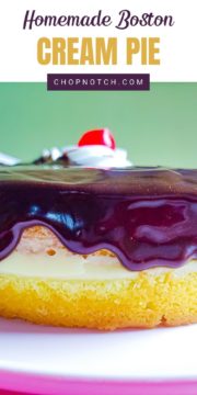 Boston cream pie topped with whipped cream and a cherry.