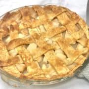 A full homemade apple pie on the table.