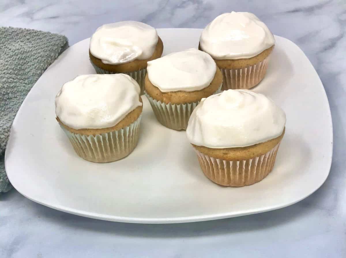 A handful of sweet potato cupcakes on a plate on a table.