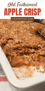 Old fashioned apple crisp in a baking dish with a spoonful missing.