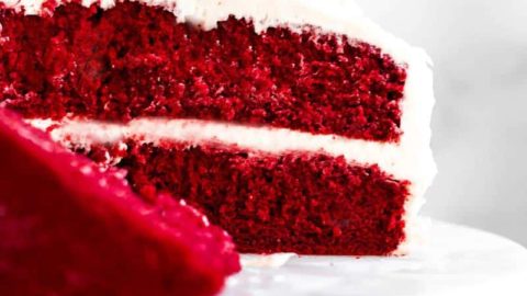 Gluten free red velvet cake on a cake stand.