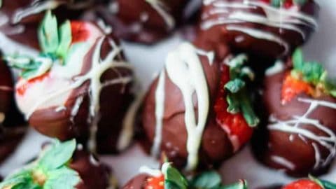 Several instant pot chocolate covered strawberries on a plate.