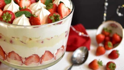 A glass bowl of strawberry trifle.