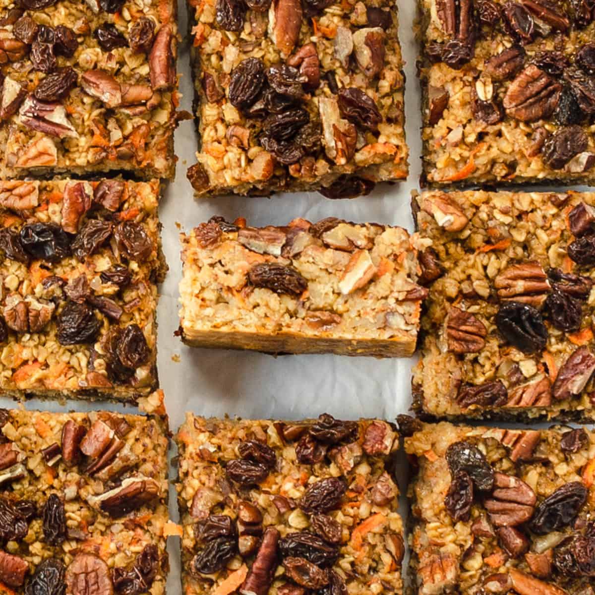 Baked carrot cake oatmeal cut into squares on a table.