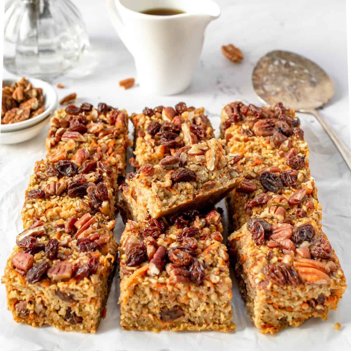 A dish with 9 carrot cake oatmeal bars on it.