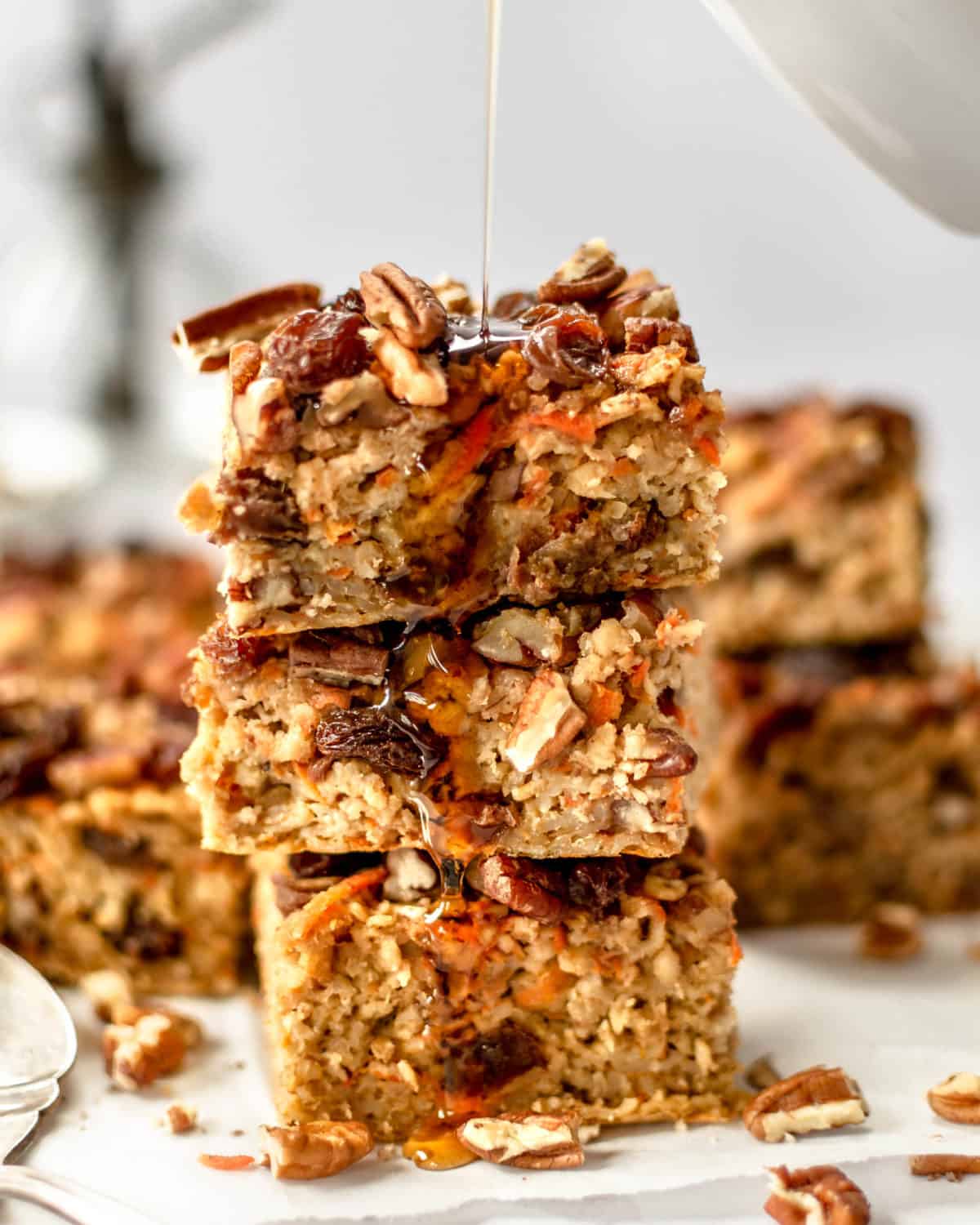 Three slices of carrot cake oatmeal stacked on top of each other.