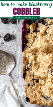 Blackberry cobbler in a baking dish with a serving spoon.