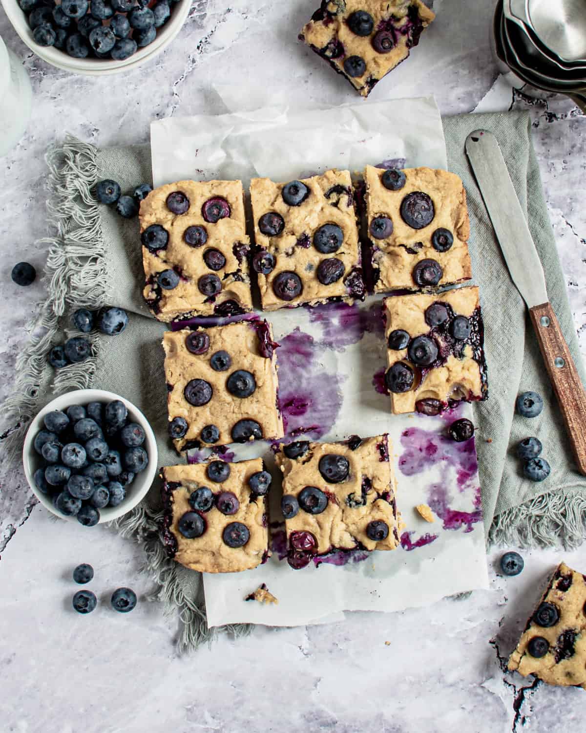 Blueberry blondies getting cut into squares.