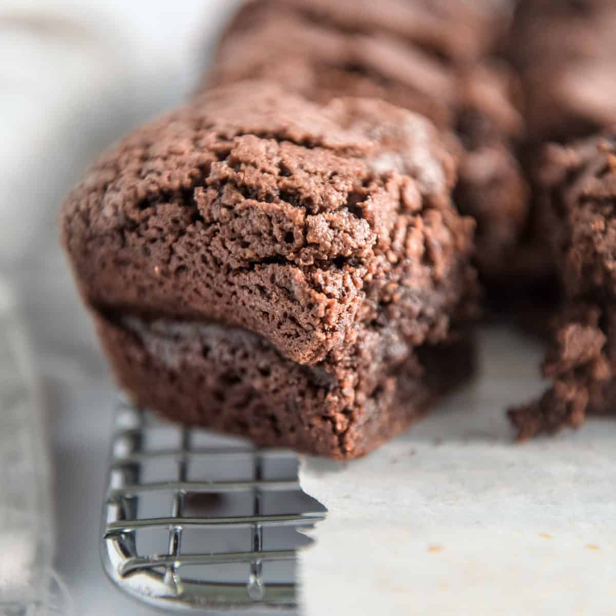 A close up of a brownie on a cooling rack.