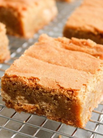 A butterscotch blondie up close on a cooling rack.