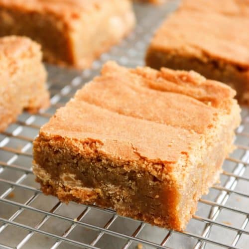 A butterscotch blondie up close on a cooling rack.