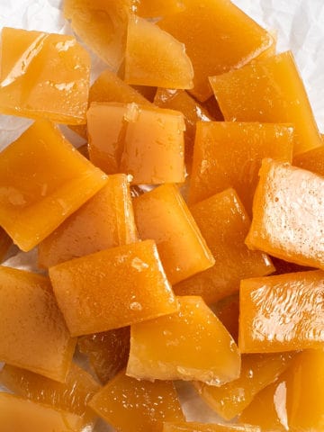 Close up of butterscotch candies in a pile.