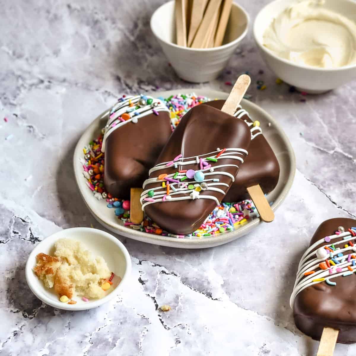 Chocolate covered vanilla cake pops in a pile ready to served.