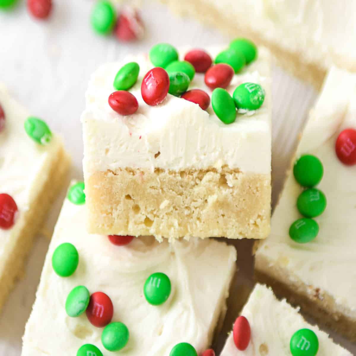 Christmas sugar cookie bars topped with red and green M&Ms.