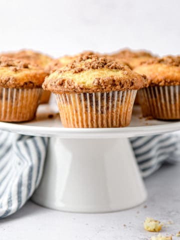 Cinnamon streusel muffins on a stand.