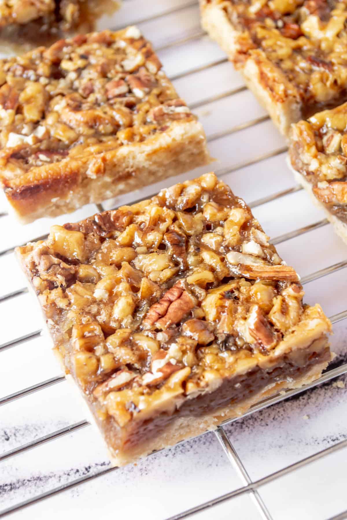 Pecan pie bars on a cooling rack.