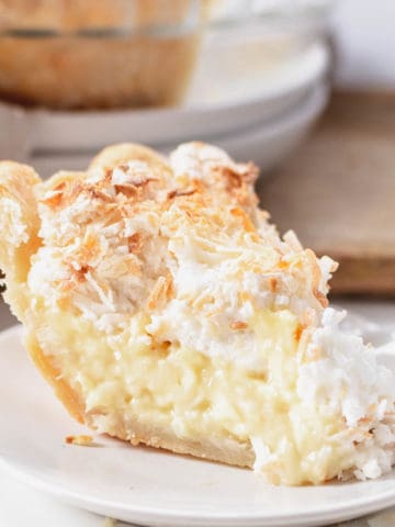 A up close piece of coconut cream pie with meringue.