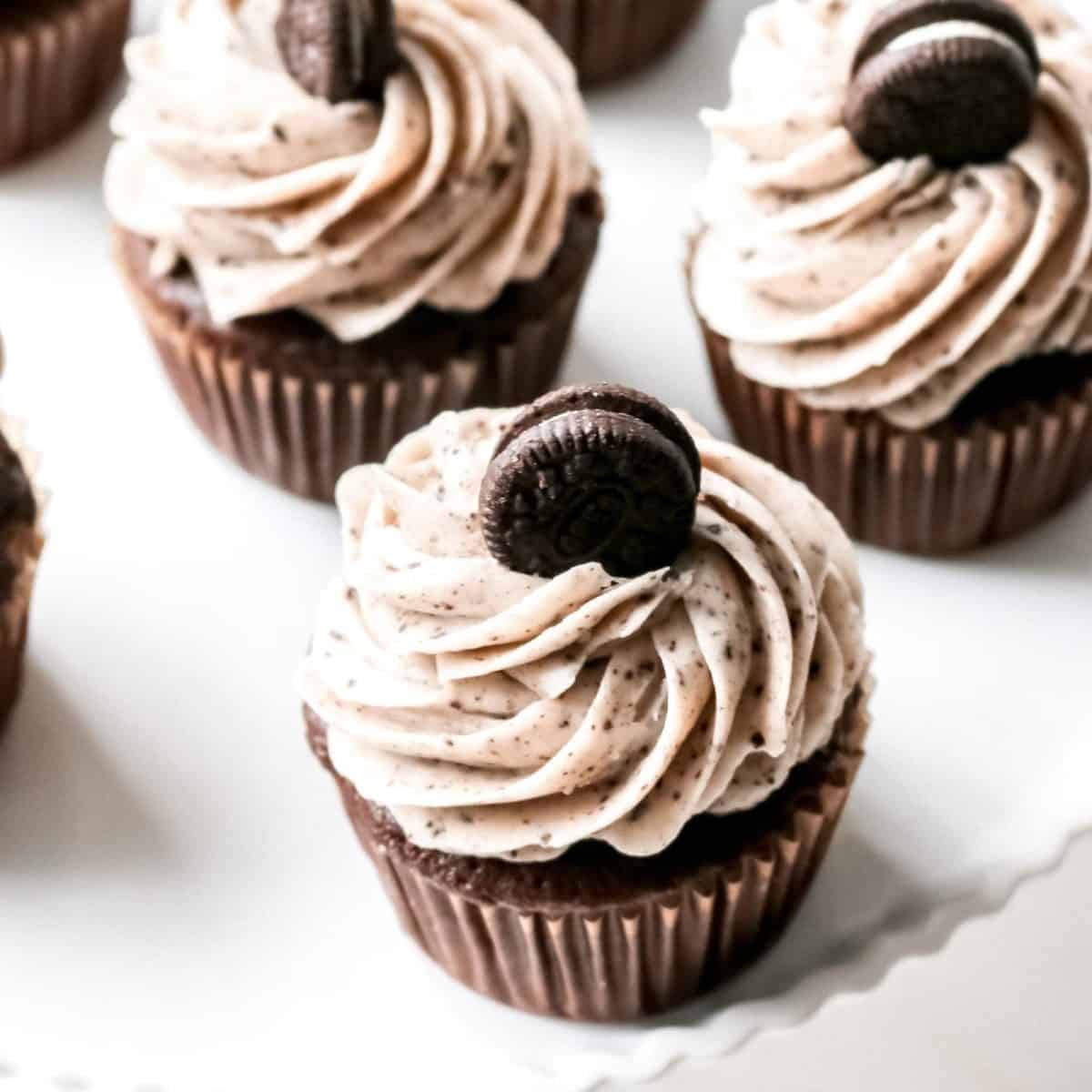 An overhead shot of chocolate cupcakes topped with mini Oreo cookies.