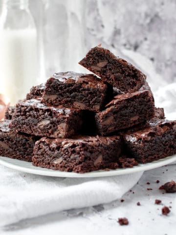 A pile of dairy free brownies in a plate.
