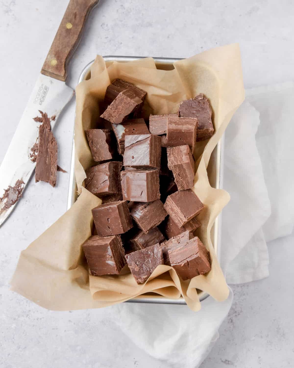 Chocolate fudge squares in a baking pan.