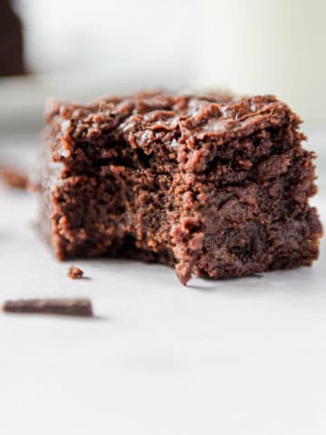 An eggless brownie with a bite taken out of it close up.