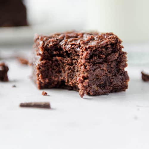 An eggless brownie with a bite taken out of it close up.