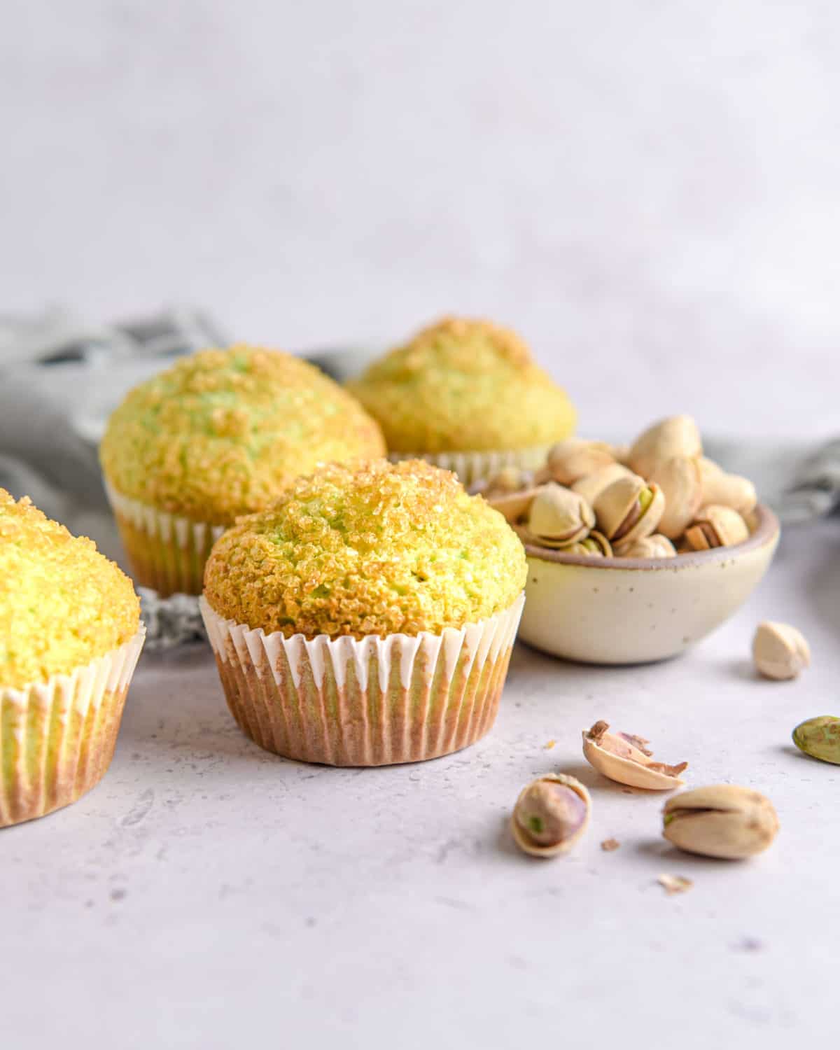 Muffins with pistachios on a table.