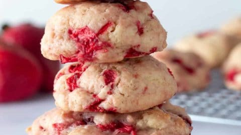 Strawberry shortcake cookies stacked on a table.