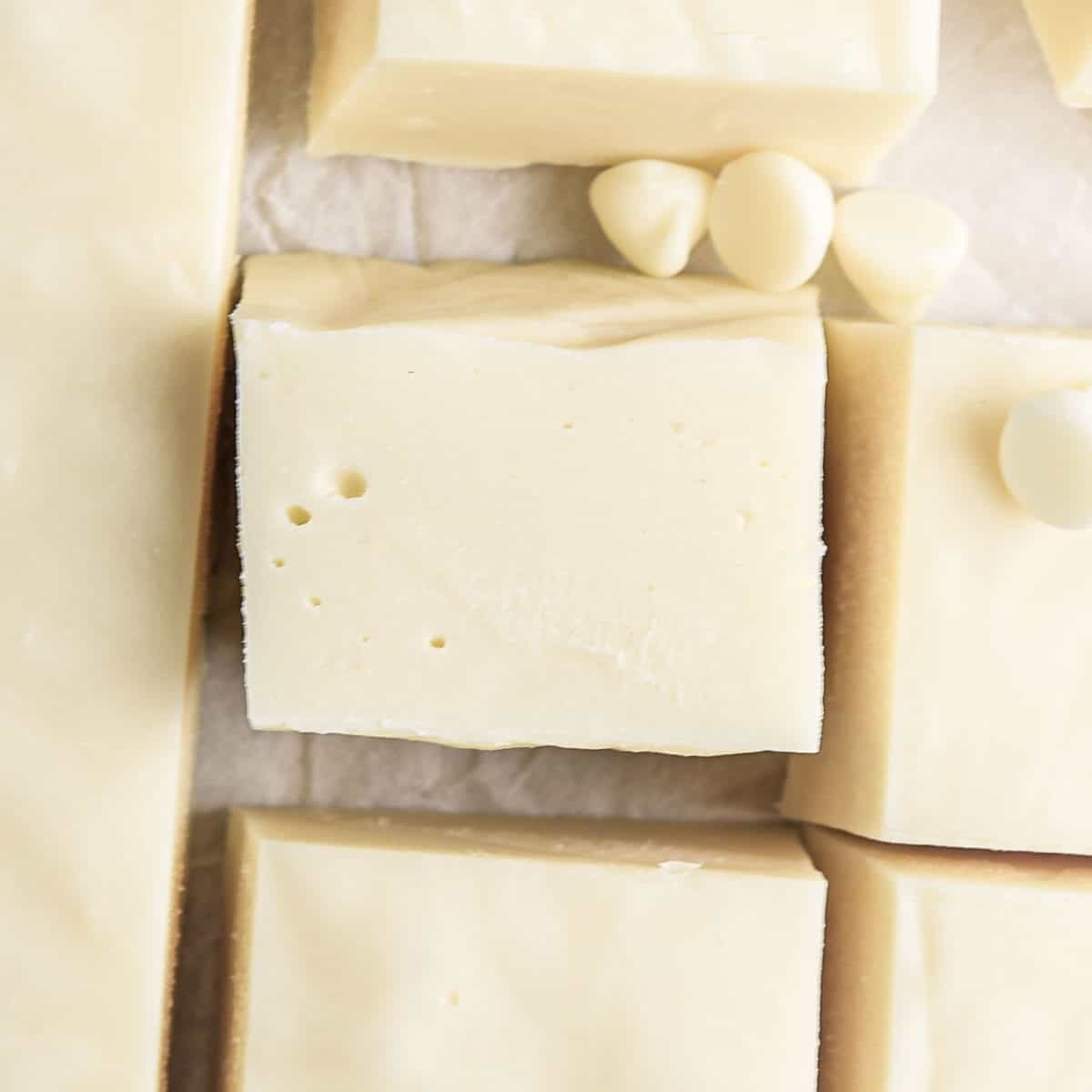 An overhead shot of white chocolate fudge cut into square blocks.