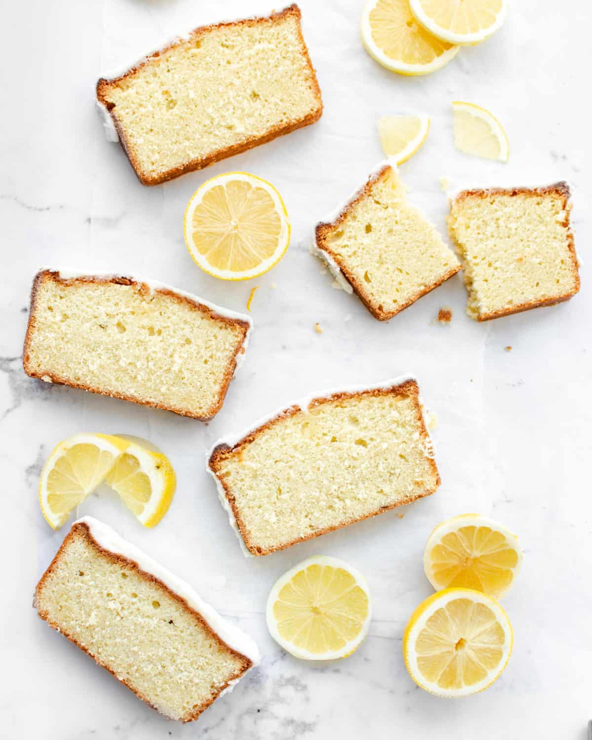Multiple slices of lemon pound cake on a table.
