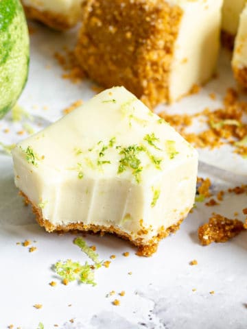 A piece of key lime fudge with a bite taken out of it.
