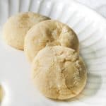 Three lemon cooler cookies on a white plate.