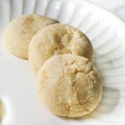 Three lemon cooler cookies on a white plate.