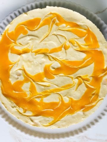 A no-bake mango cheesecake overhead shot.