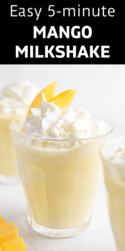 Finished mango milkshake in a glass topped with whipped cream.