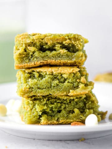 A stack of matcha brownies on a white plate.