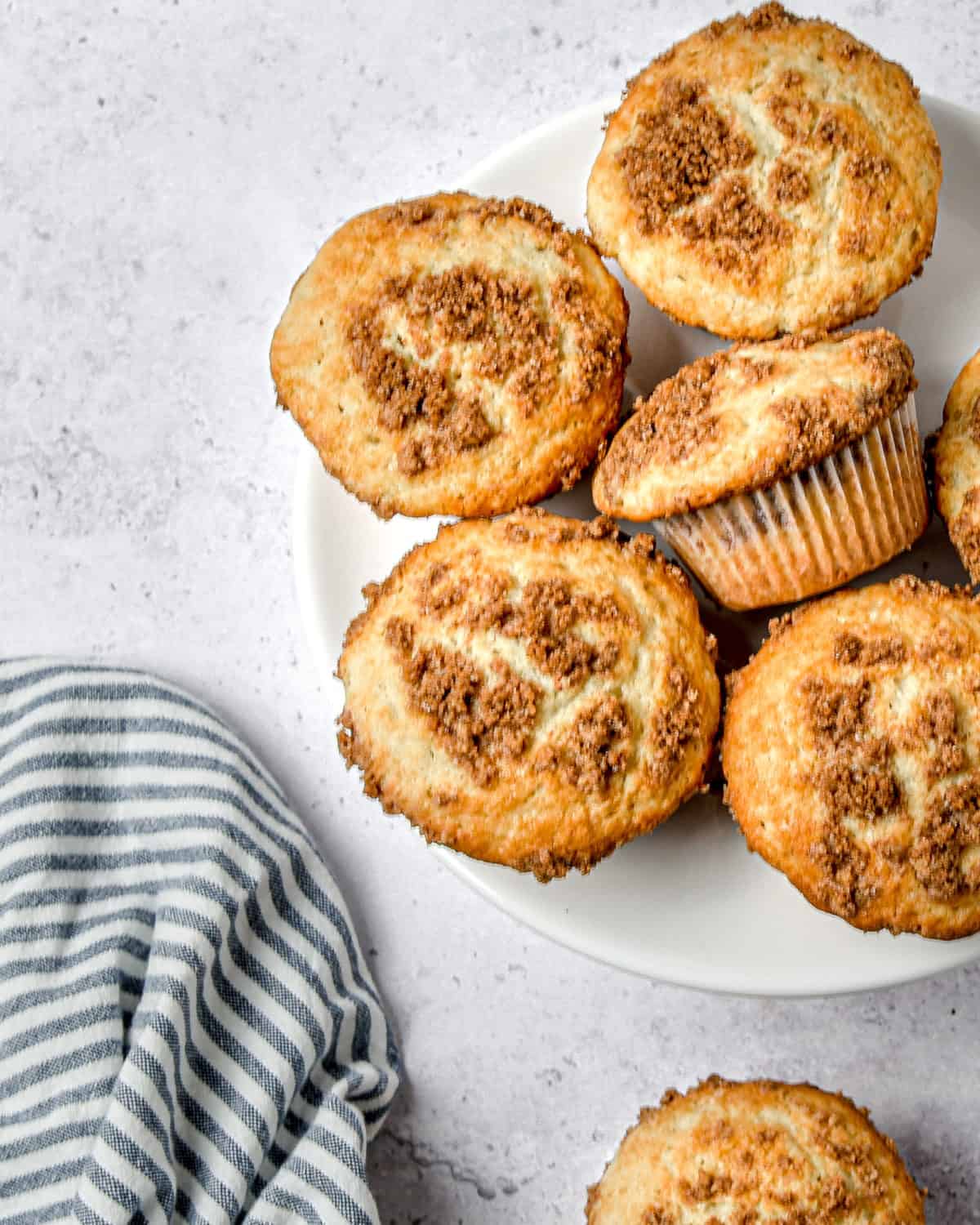 Cinnamon streusel muffins on a white plate.