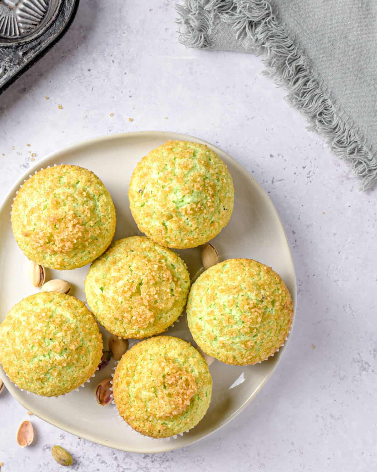 Green muffins on a white plate ready to be served.