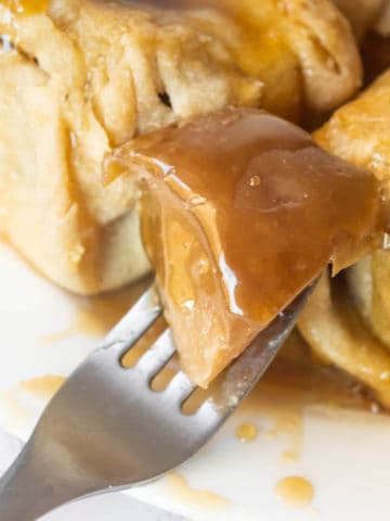 A bite of apple dumpling on a fork.