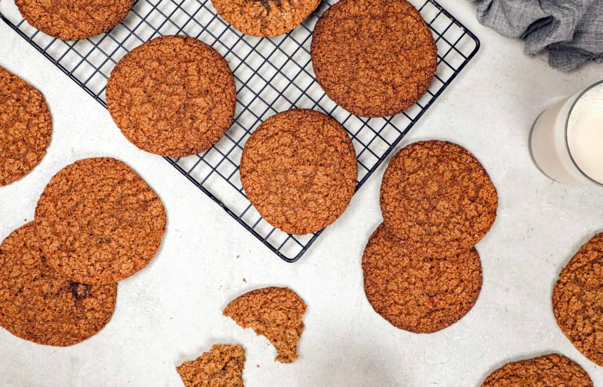 Several molasses cookies spread out on a table.