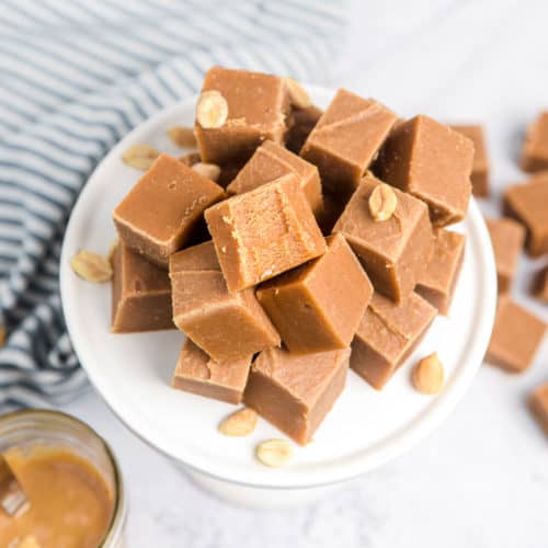 A pile of old fashioned peanut butter fudge squares on a plate.