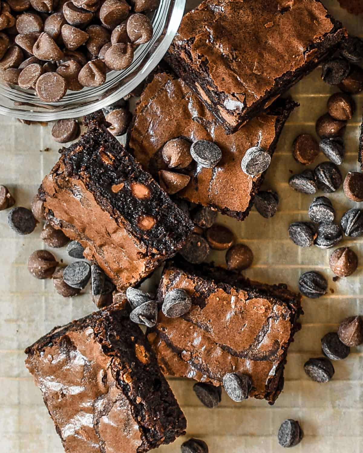A pile of brownies and chocolate chips on a table.