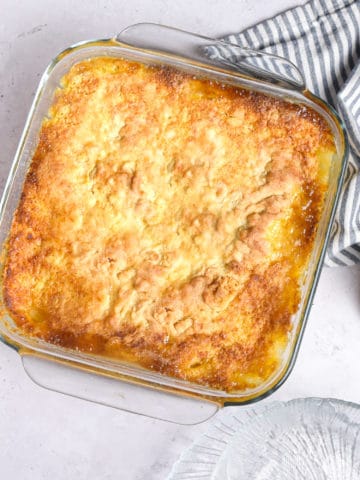 Peach cobbler with cake mix in a baking dish.