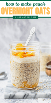 A glass jar of finished peach overnight oats on a table with a spoon in it.