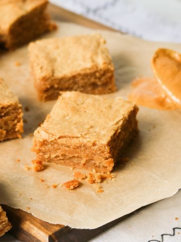 Peanut butter blondies spread out on a table.