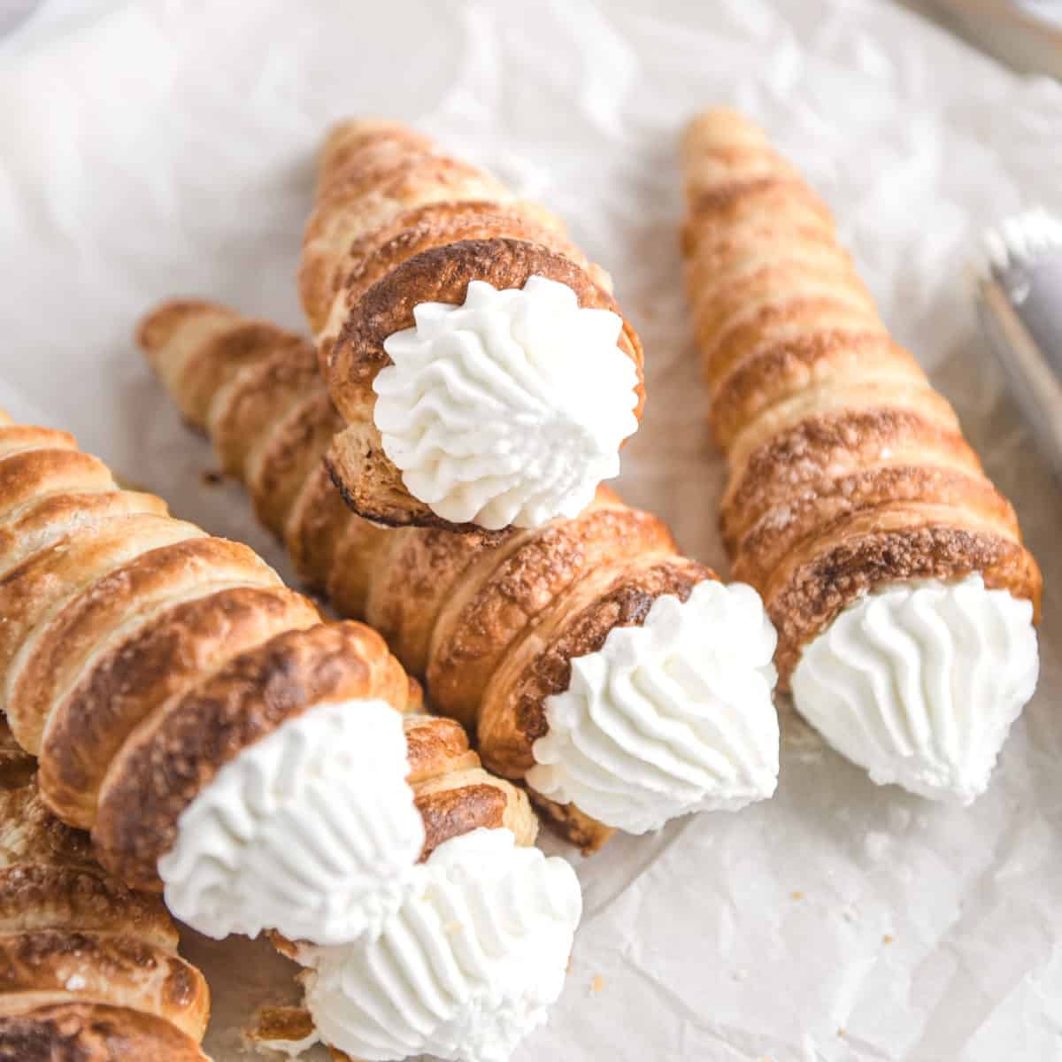 A close up of a stack of cream horns.