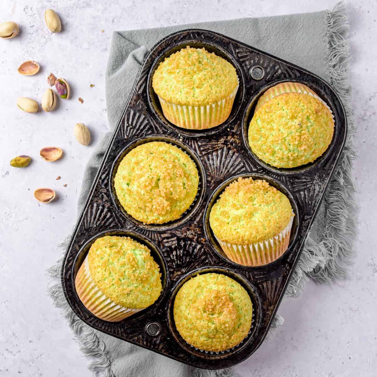 An overhead shot of six muffins in a muffin tin.